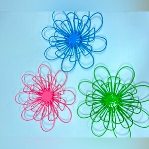 3 bright colored metal flowers